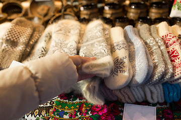 Image showing woman buying woolen mittens at christmas market