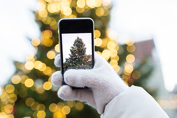 Image showing hands with smartphone photographing christmas tree