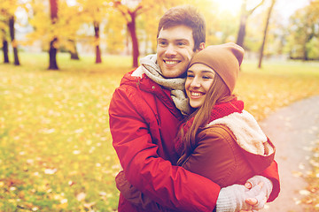 Image showing happy young couple hugging in autumn park