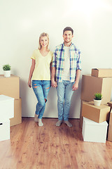 Image showing smiling couple with big boxes moving to new home