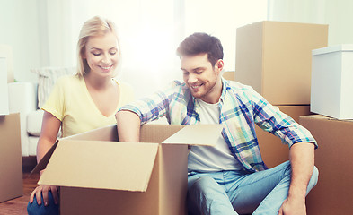 Image showing smiling couple with big boxes moving to new home