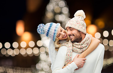 Image showing happy couple hugging over christmas lights