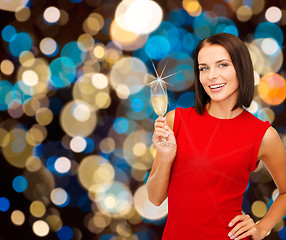 Image showing smiling woman holding glass of sparkling wine