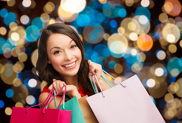 Image showing smiling woman with colorful shopping bags