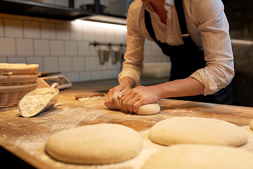 Image showing baker making bread dough at bakery kitchen