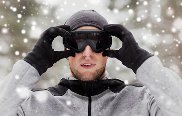 Image showing sports man with ski goggles in winter outdoors