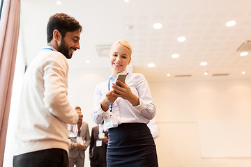 Image showing couple with smartphone at business conference