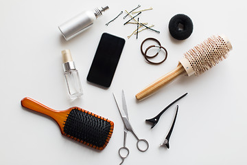 Image showing smartphone, scissors, brushes and other hair tools