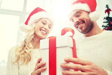 Image showing happy couple at home with christmas gift box