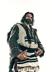 Image showing Portrait of a brutal bald-headed viking in a battle mail posing against a white background.