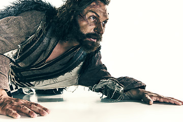 Image showing Portrait of a brutal bald-headed viking in a battle mail posing against a white background.