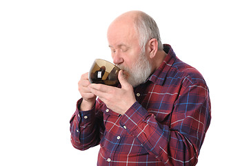 Image showing senior man drinking from cup, isolated on white