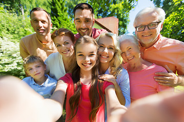 Image showing happy family taking selfie in summer garden