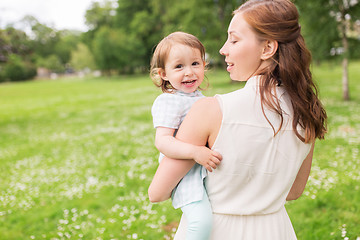 Image showing happy mother holding baby girl at summer park