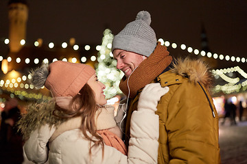 Image showing happy couple holding hands at christmas tree