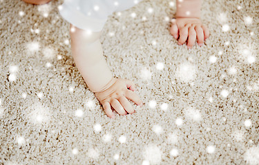 Image showing hands of baby crawling on floor or carpet