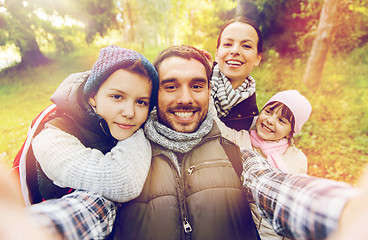 Image showing family with backpacks taking selfie and hiking