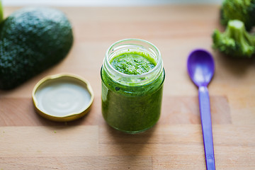 Image showing jar with puree or baby food on wooden board