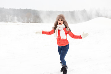 Image showing happy woman in winter fur hat having fun outdoors