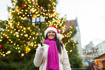 Image showing woman taking selfie with smartphone at christmas 