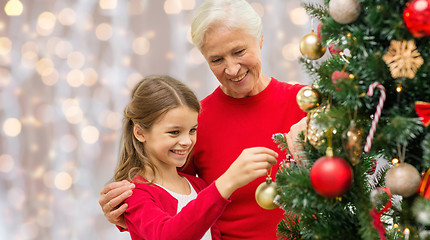 Image showing grandmother and granddaughter at christmas tree