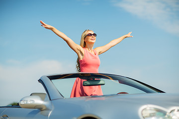 Image showing happy young woman in convertible car