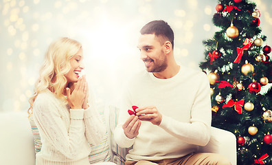 Image showing man giving woman engagement ring for christmas