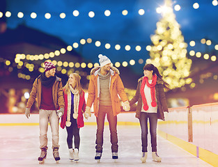 Image showing happy friends at christmas skating rink