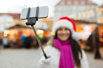 Image showing woman taking selfie by smartphone at christmas 