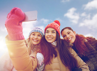 Image showing happy teenage girls taking selfie with smartphone