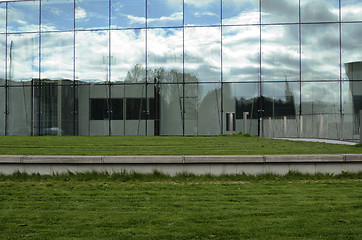 Image showing green lawn and glass facade of a modern building