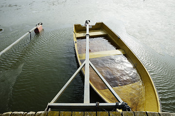 Image showing a boat flooded with water at the pier