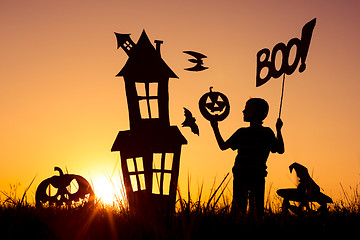 Image showing Happy little boy playing outdoors at the sunset time.