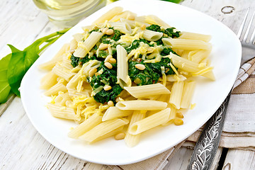 Image showing Pasta penne with spinach and cedar nuts on board