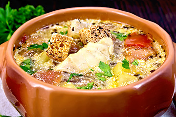 Image showing Soup fish with vegetables and cream on dark board