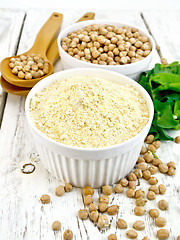 Image showing Flour chickpeas in white bowl with peas on light board