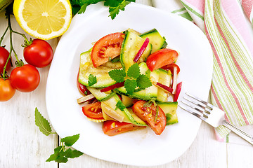 Image showing Salad with zucchini and tomato in plate on board top