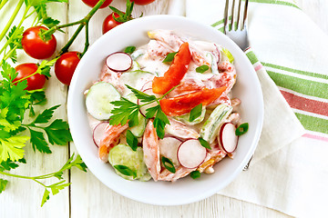 Image showing Salad from fresh vegetables in plate on board top