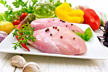 Image showing Chicken breast raw in plate with vegetables on board