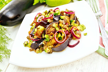 Image showing Salad from eggplant and cucumber in plate on board