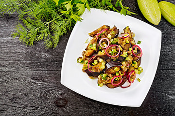 Image showing Salad from eggplant and cucumber in plate on black board top