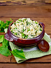 Image showing Couscous with spinach in bowl on wooden board