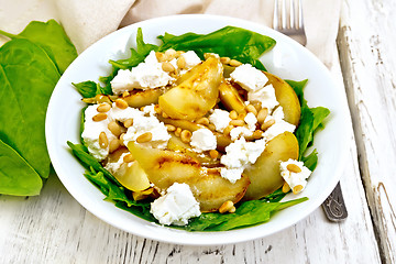 Image showing Salad from pear and spinach in dish on board