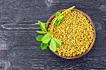 Image showing Fenugreek with leaf in clay bowl on board top