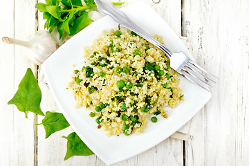 Image showing Couscous with spinach in plate on board top