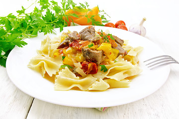 Image showing Farfalle with turkey and vegetables in sauce on board