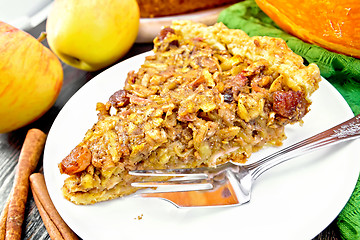 Image showing Pie with pumpkin and apples on dark board