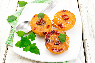 Image showing Quince baked with mint in plate on board