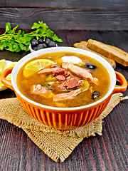 Image showing Solyanka with olives in bowl on dark board