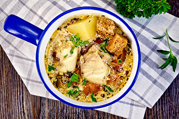 Image showing Soup fish with vegetables and croutons on board top